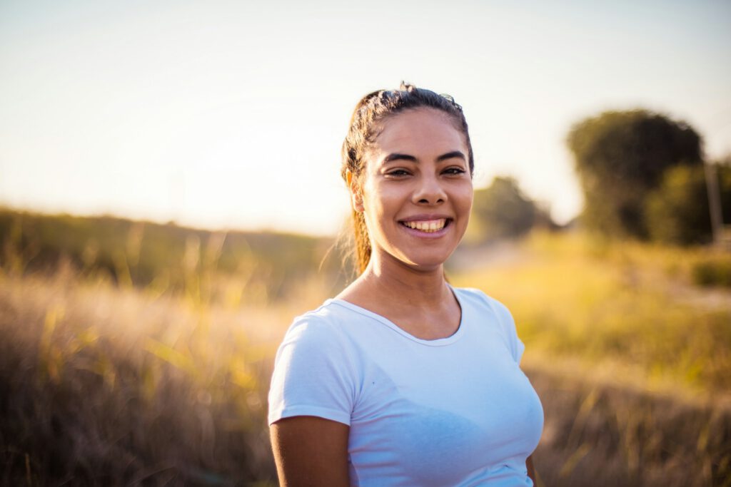 Woman Smiling In Field